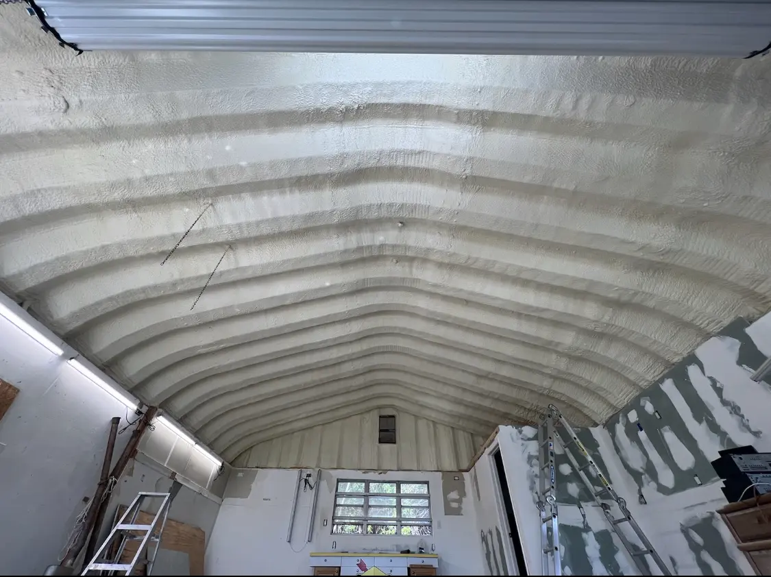 Spray polyurethane foam applied to the underside of a metal roof deck in Cloverly